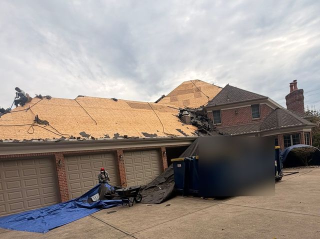 Old shingles torn off down to the roof deck over the garage during a roof replacement in Allison Park, PA.