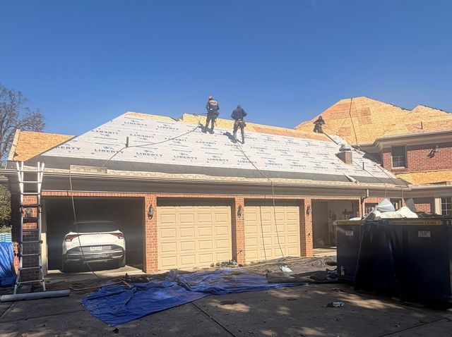 Crew installing underlayment over the garage roof during a full roof replacement in Allison Park, PA.