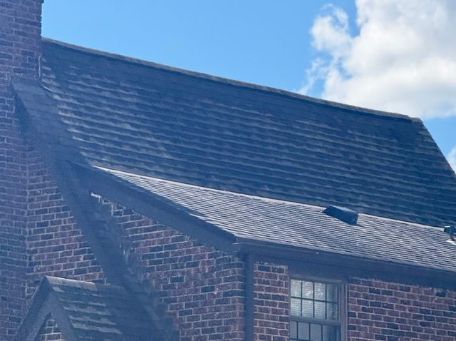 Worn dark asphalt shingles on a brick home in South Hills, Pittsburgh, PA, before replacement.