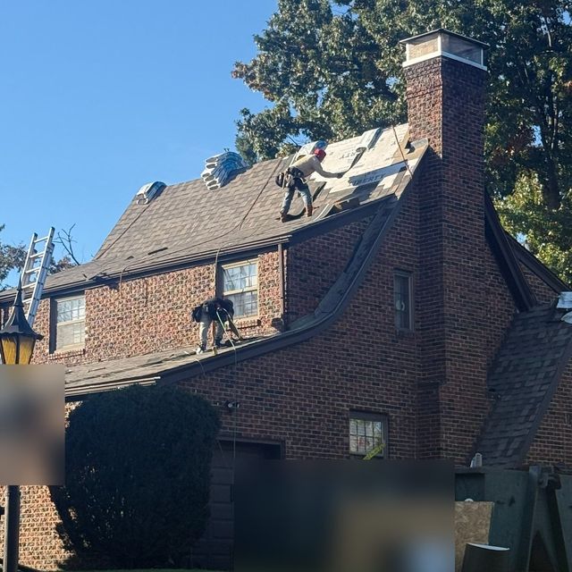Crew tearing off the old roof on a brick home in South Hills, Pittsburgh, PA.